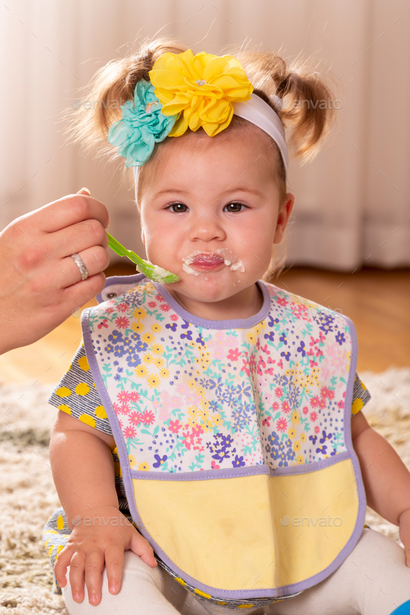 Baby girl eating pap