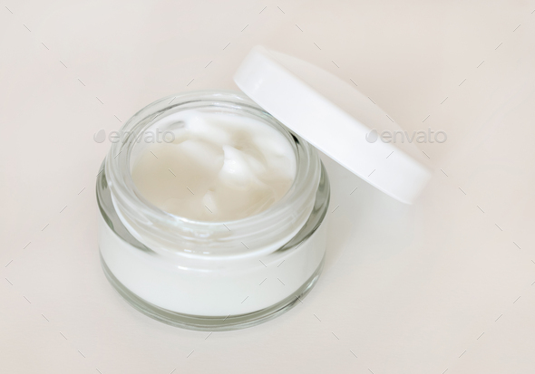 Opened Cosmetic jar with a lid on white close up, mockup. Everyday skincare routine