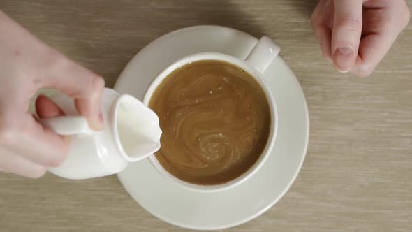 Delicious and Flavored Hot Coffee Rotating in White Cup After It Was Stirred alt
