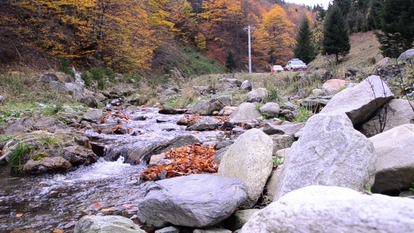 Column Of Cars Near A Mountain River 