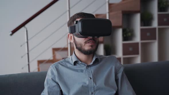 Man Using Virtual Glasses and Spending Free Time at Home