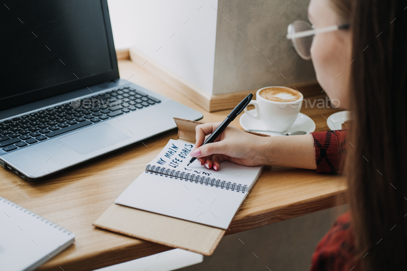 Main life goals, How to Set and Achieve Life Goals. Young woman girl writing in notebook life goals