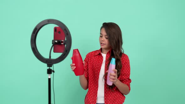 Happy Teen Girl Beauty Blogger Has Long Curly Hair Making Video Review of Shampoo Choice alt