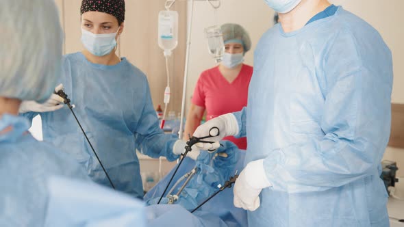 Portrait of Female Medical Worker in Protective Mask and Sterile Gloves Holding alt