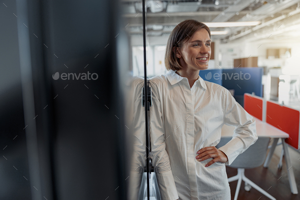Portrait of smiling european business woman in casual clothe standing in modern office