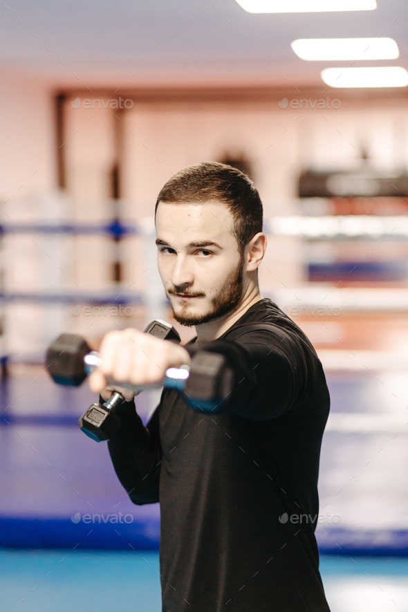 Boxers train in the ring and in the gym Stock Photo by yavorandriy