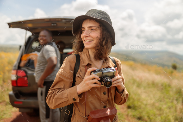 Happy female traveler enjoying the journey through the savannah