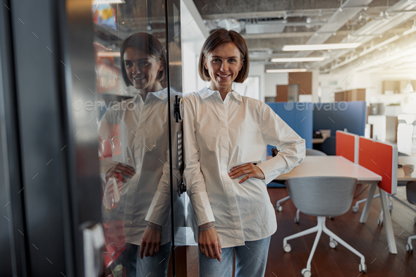 Portrait of attractive european business woman in casual clothe standing in modern office