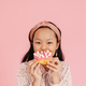 Asian girl wearing headband smiling while eating doughnut - PhotoDune Item for Sale