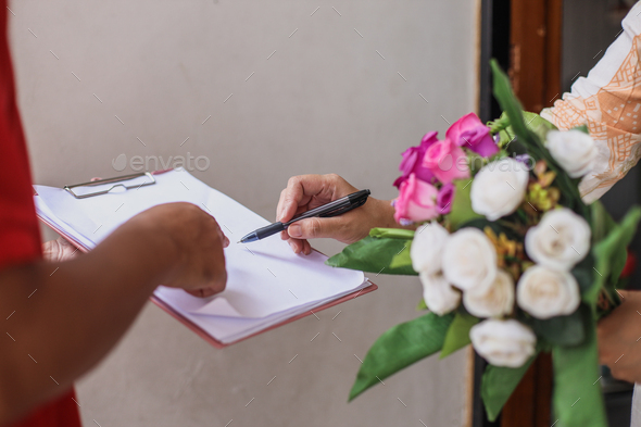Customer sign on document, delivering flowers.