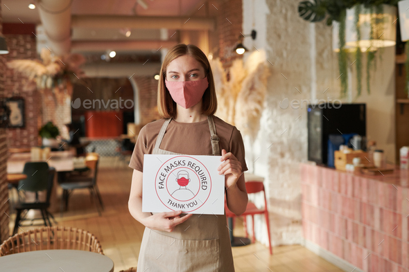 Cafe Worker Holding Requirement Sign