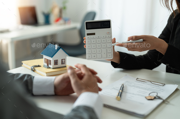 Real estate agent showing financial rate home loan for sign agreement customer the contract legally