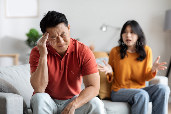 Emotional asian spouses having fight at home
