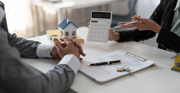 Real estate agent showing financial rate home loan for sign agreement customer the contract legally