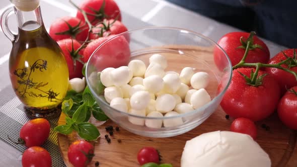Mozzarella Cheese Small Balls Falling Into Glass Bowl alt
