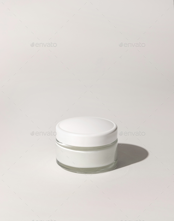Cosmetic jar with a lid on white close up, mockup. Everyday skincare routine