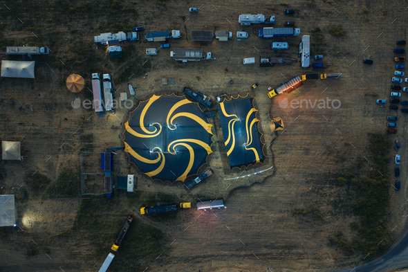 Big top of a circus with caravans in a field