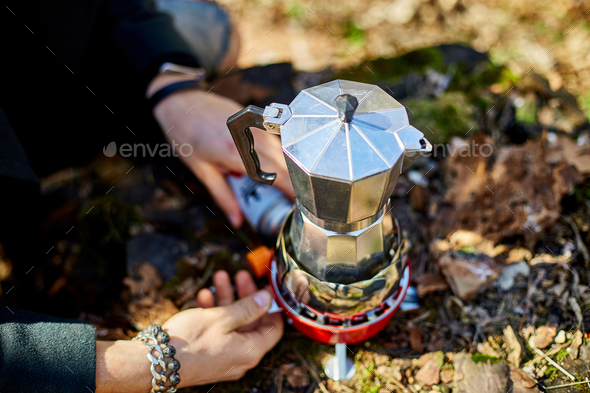 Making camping coffee from a geyser coffee maker on a gas burner