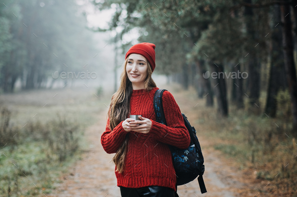 Sustainable tourism, responsible travel. Young woman traveler with backpack holding tremors zero