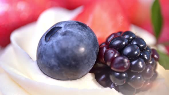 Composition of Ripe Genuine Black and Red Berries on White Fluffy Whipped Cream Extreme Closeup alt