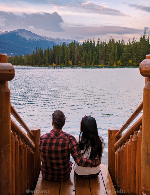couple at beauvert lake, sunrise by lake at Jasper , Lac Beauvert Alberta Canadian Rockies Canada