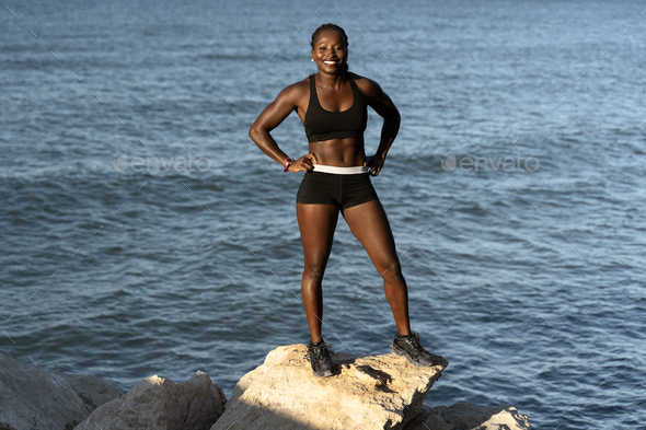 Fitness sport model smiling happy after outdoor work out on sunny summer day