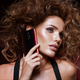 Beautiful woman handling phon. Bright makeup and beautiful hairstyle - PhotoDune Item for Sale