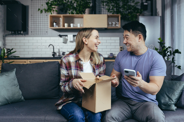 Young happy couple received a parcel, happy and satisfied with shopping in online store