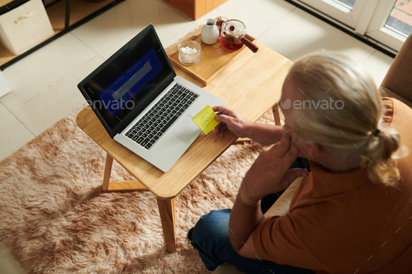 Senior Man Writing Password - Stock Photo - Images