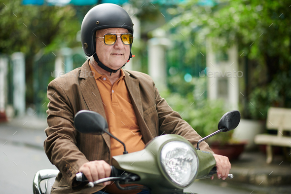Elderly Man Riding on Scooter