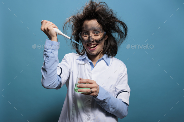 Insane scientist grinning creepy while dripping chemical compounds from pipette into glass flask