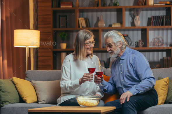 Romantic loving senior affectionate couple celebrating Anniversary at home. Happy elderly mature