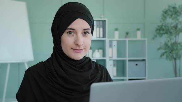 Muslim Businesswoman Freelancer in Black Hijab Working Typing on Laptop Using Computer Service for alt
