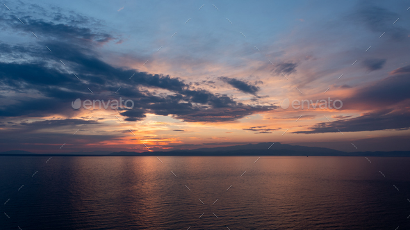 Colourful sunset over the sea at Greek island Thassos - Stock Photo - Images