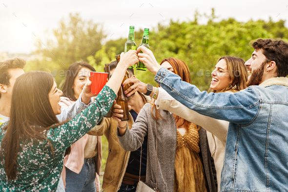 Cheerful friends gathering raising beers for a celebratory toast Stock ...