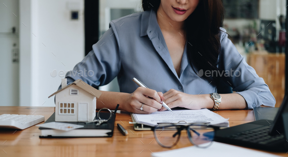 Hands of businesswoman signing leasing home documents and have a apartment keys on paperwork - Stock Photo - Images