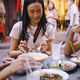 A group of multi-ethnic female friends enjoying street food in Bangkok, Thailand. - PhotoDune Item for Sale
