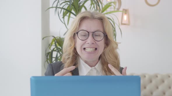 Close-up of Confident Language Teacher Teaching Online Lesson on Covid-19 Pandemic Lockdown alt