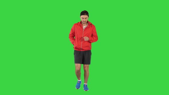 Young Man Running in a Windbreaker on a Green Screen Chroma Key alt