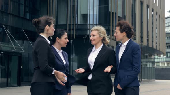 Happy Middle-aged Business People Friends Talking Laughing at Group Meeting Next To Office Building alt