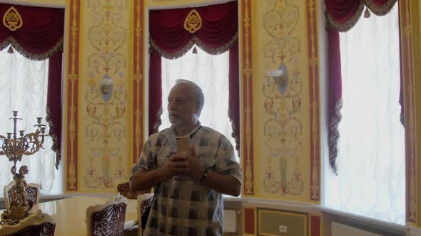 Pensioner with Mustache Takes Photo of Beautiful Museum Room alt