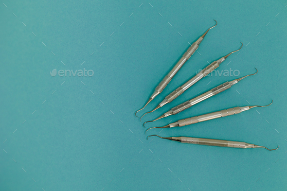 Periodontal Scaler And Dental Probes On Blue Background Stock Photo By ...