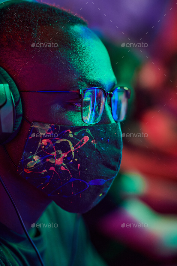 Focused gamer in cool mask