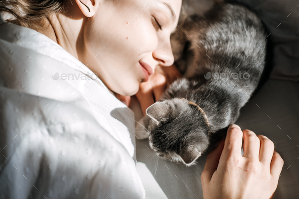 Mindfulness, Being in the present moment, here and now. Young woman play with kitten at home in