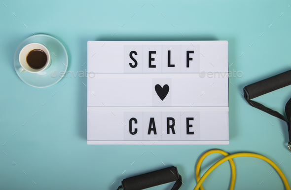 Self care word on lightbox on blue background. Take care of yourself