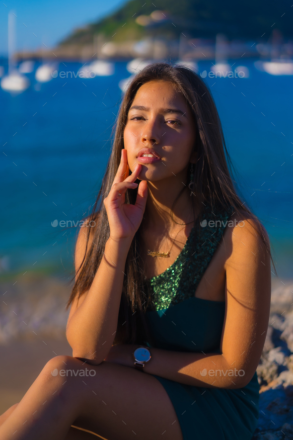 A Hispanic girl at the beach on a summer day enjoying the day