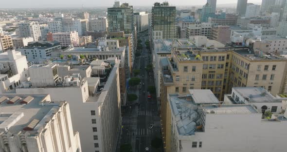 Drone Flying Above City Streets of Downtown Los Angeles, Cars Below Surrounded by Beautiful Building alt