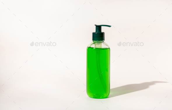 Cosmetic pump dispenser bottle filled with green liquid on white, aloe vera skincare product