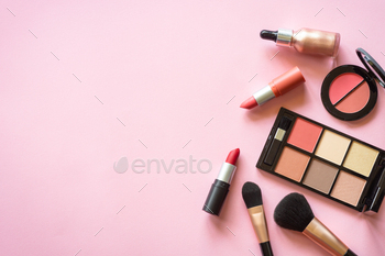 Makeup professional cosmetics on pink background.