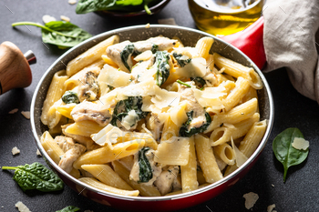 Pasta penne with chicken and spinach in creamy sauce.